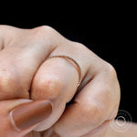 Minimal pave moissanite half eternity band worn on finger close-up