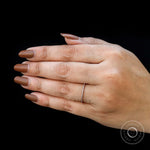 Classic pave moissanite wedding band shown worn as matching band