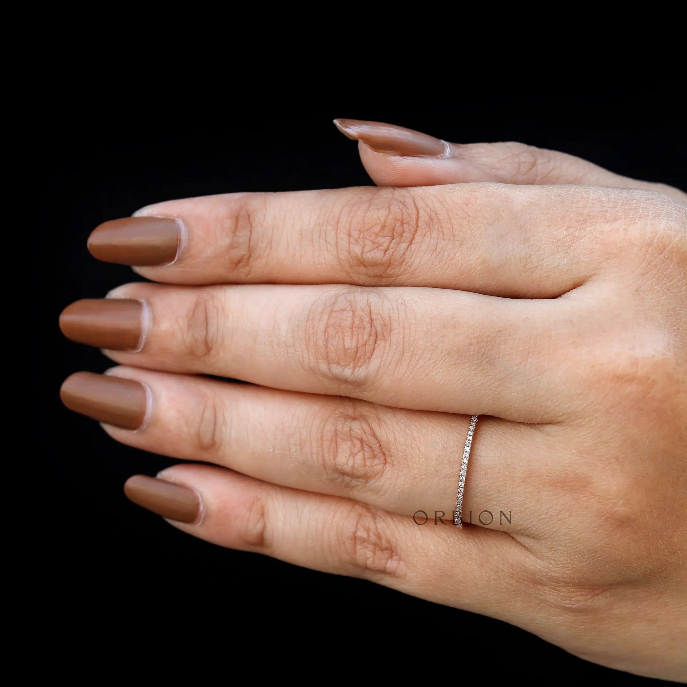 Classic pave moissanite wedding band shown worn as matching band