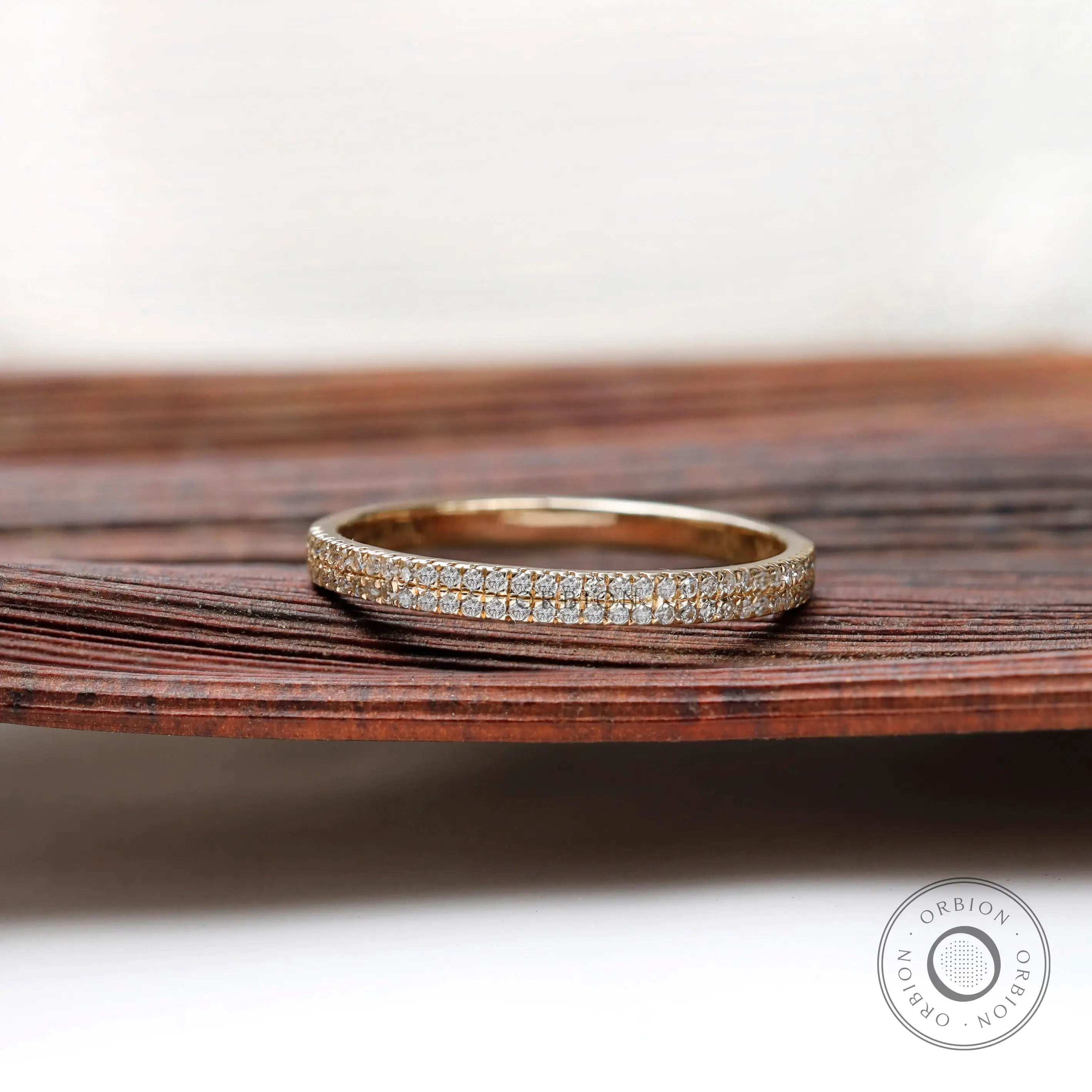 Front view of double row pave half eternity band