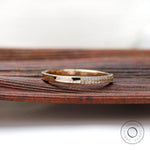 Angled view showing dual pave rows and polished gold