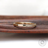 Angled view showing dual pave rows and polished gold