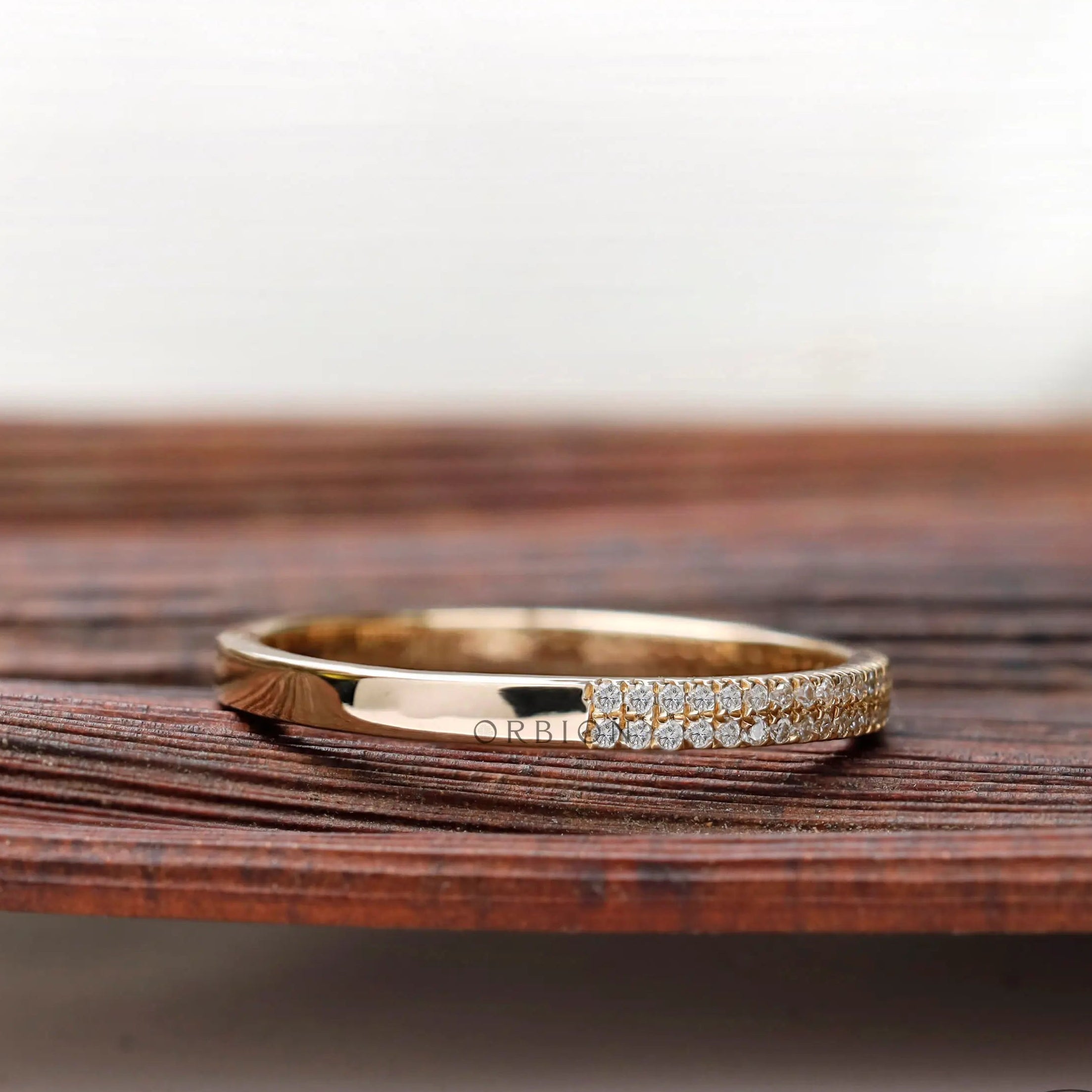 Angled view showing dual pave rows and polished gold
