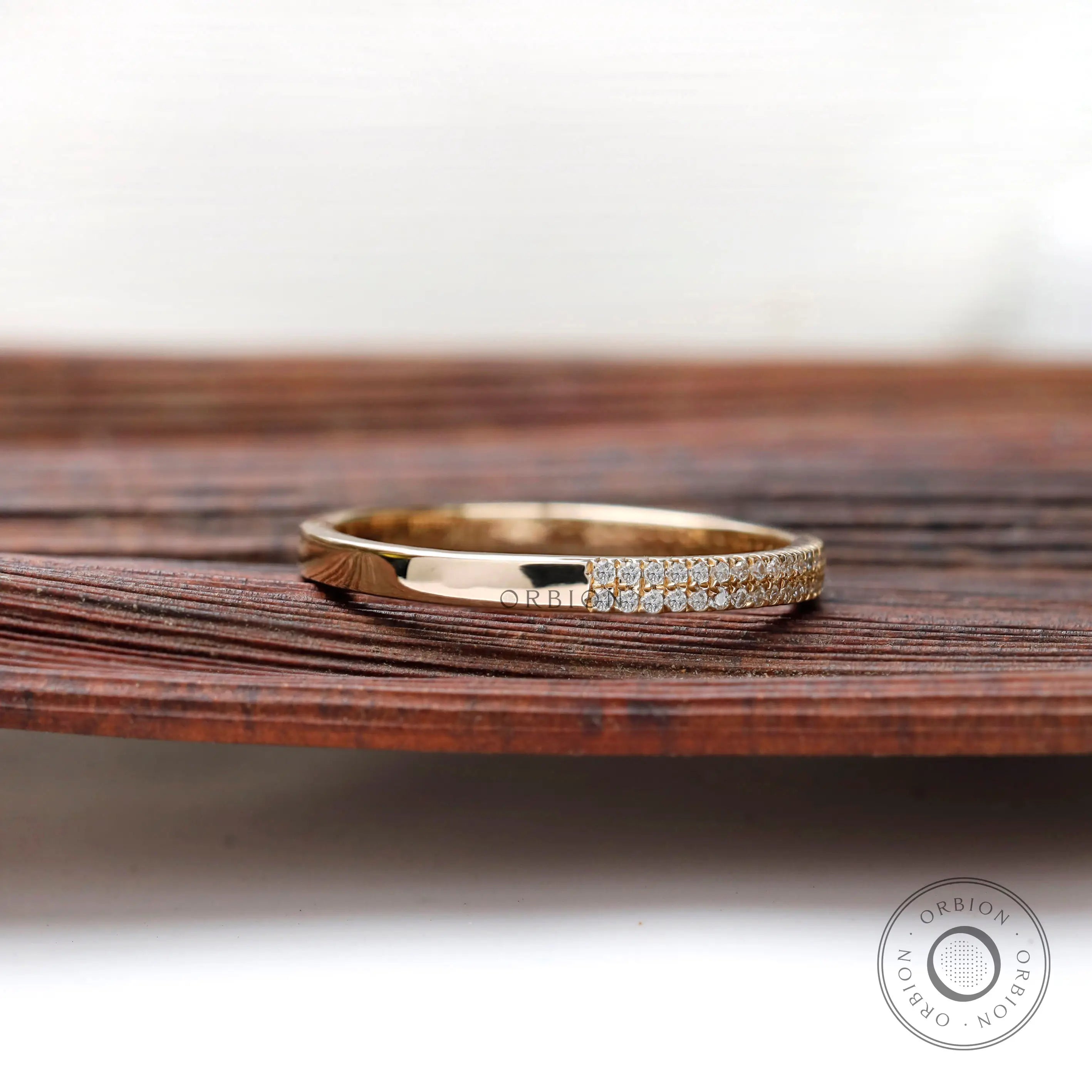 Angled view showing dual pave rows and polished gold