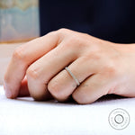On hand view of minimalist pave wedding band