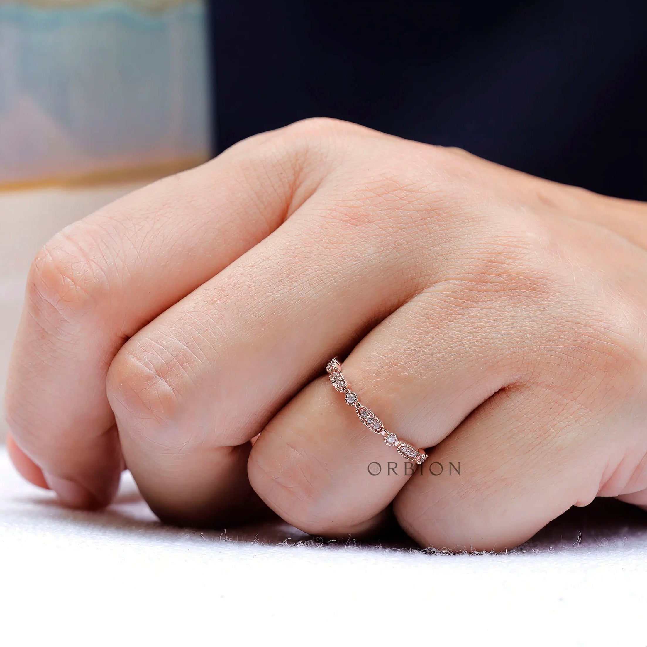 On-hand view showing delicate geometric band scale
