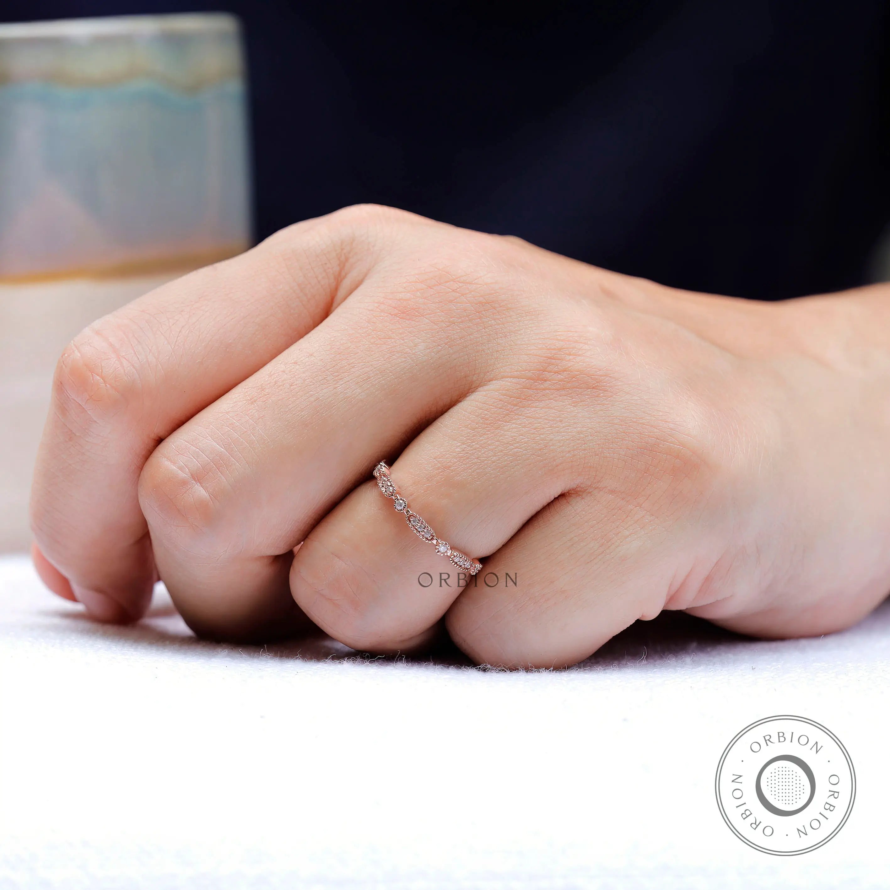 On-hand view showing delicate geometric band scale
