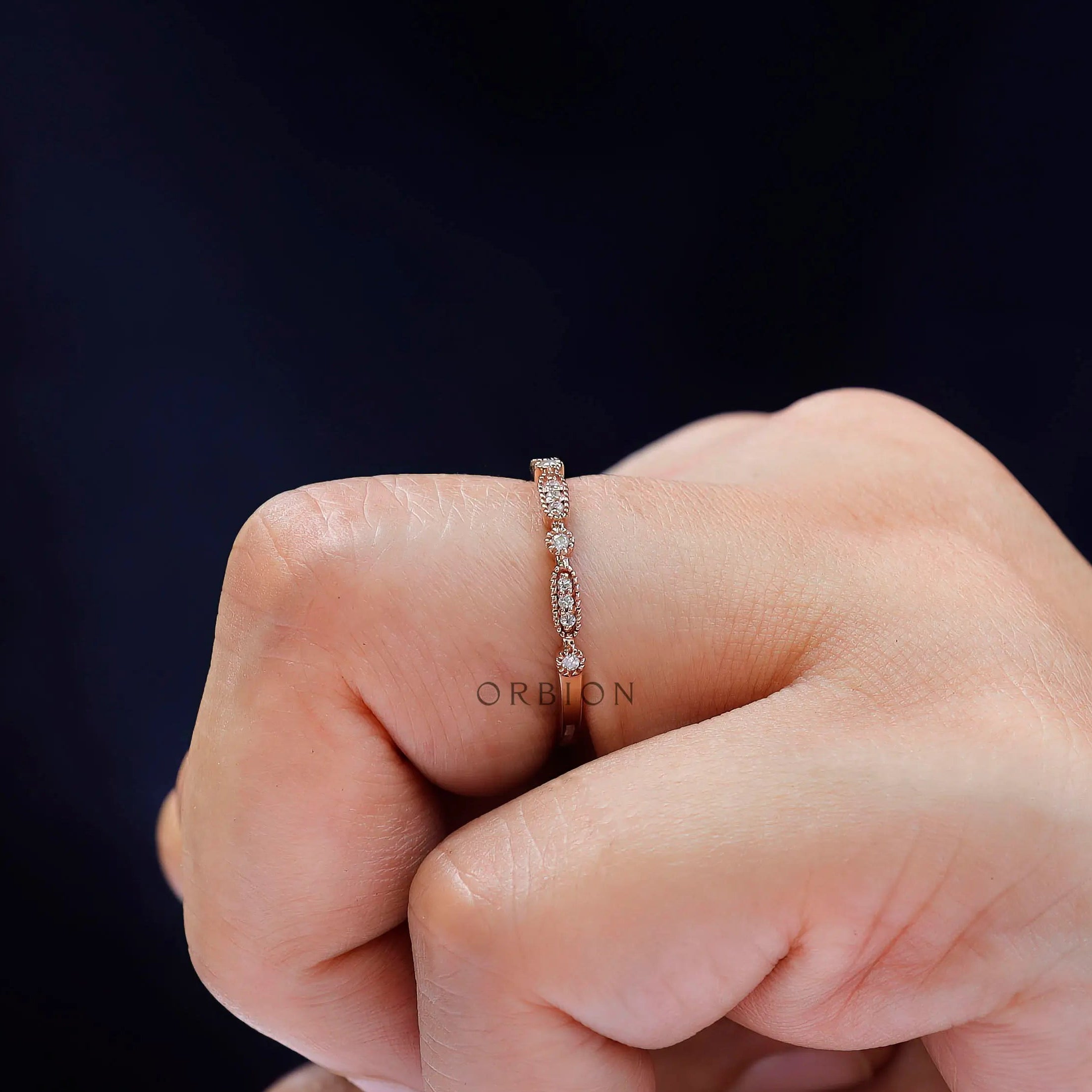 Side profile of geometric gold band worn on hand