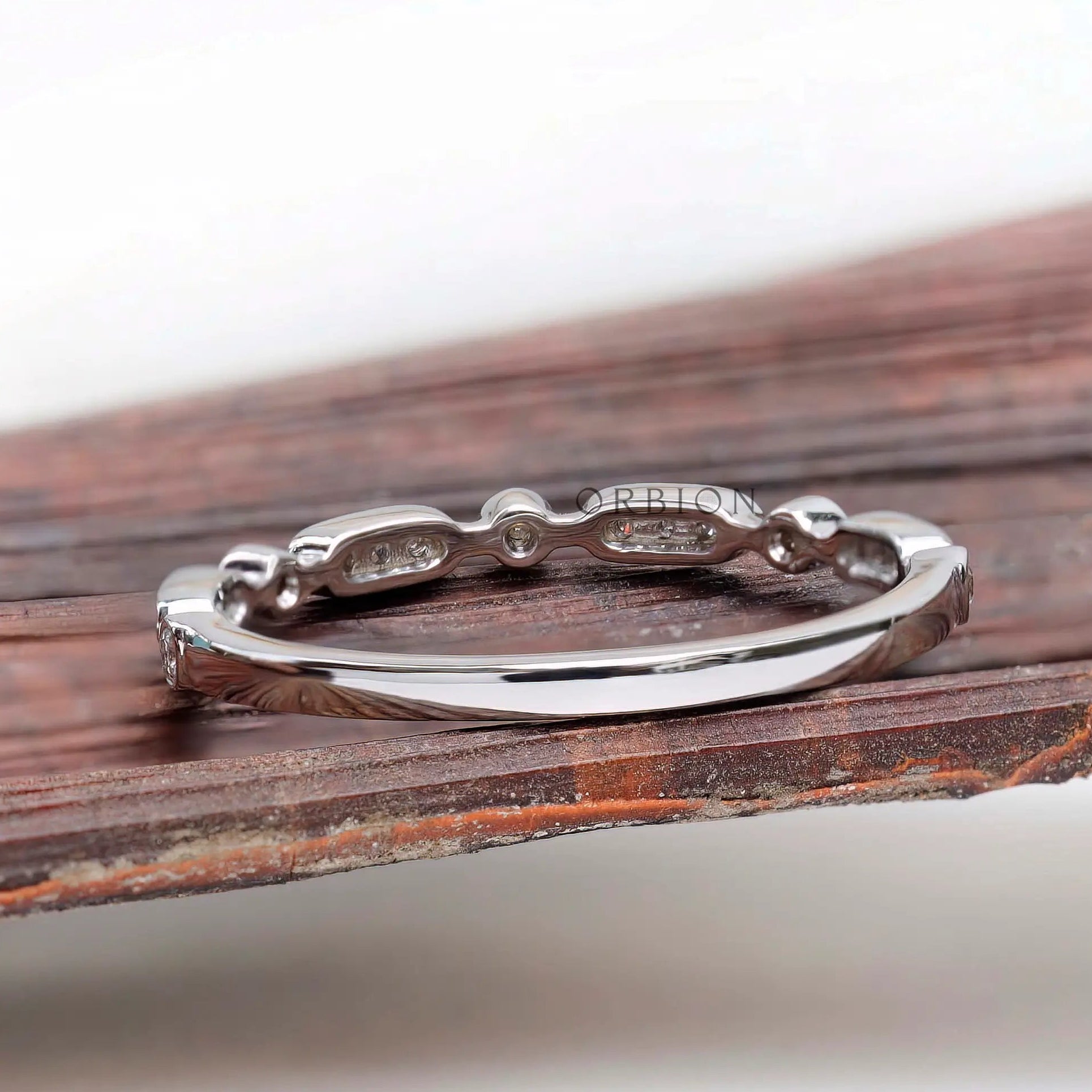 Back view of the thin geometric band showing smooth plain shank and gallery along the top.