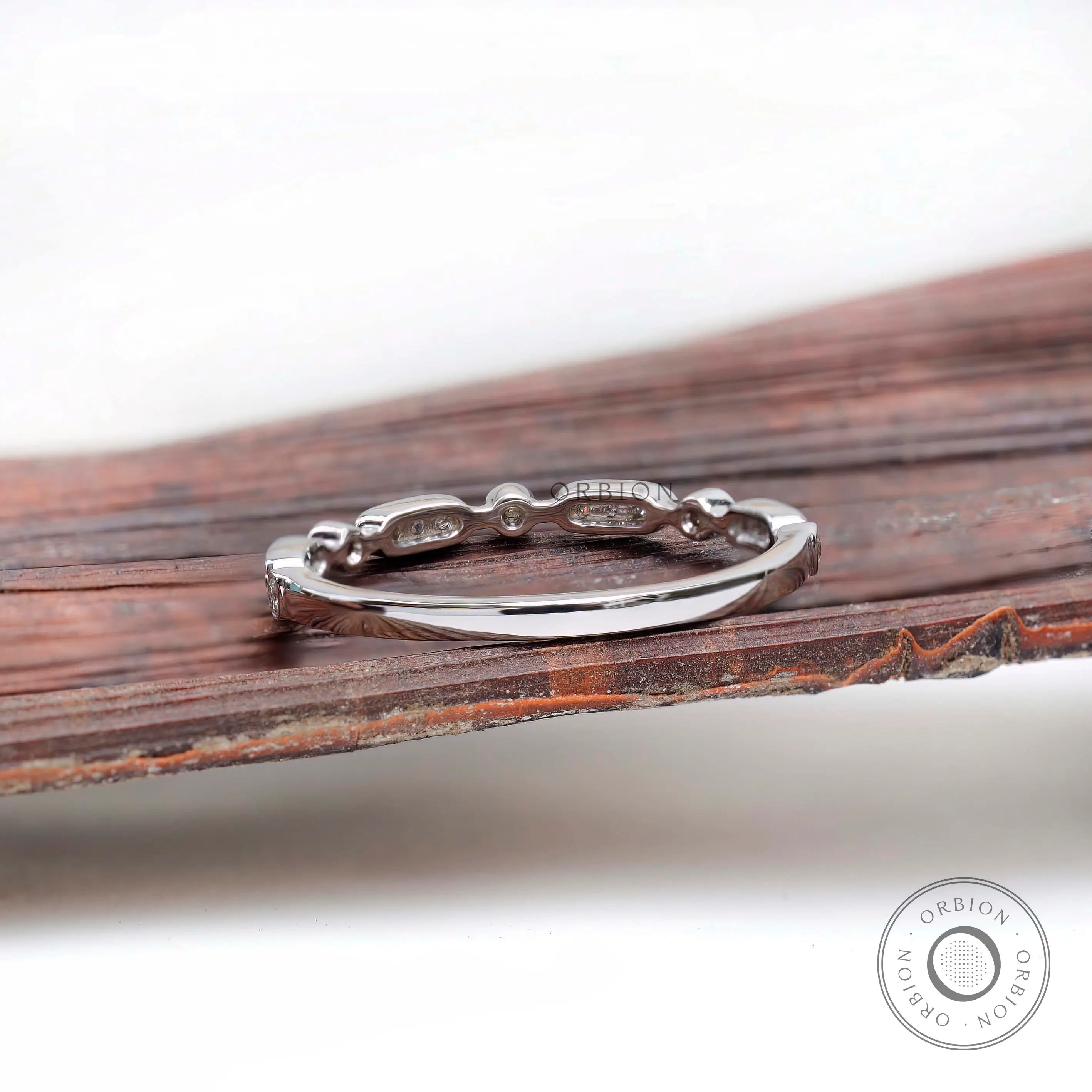 Back view of the thin geometric band showing smooth plain shank and gallery along the top.