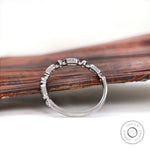 Side profile of geometric band highlighting the height and open gallery details.