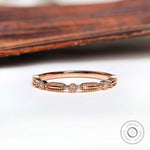 Front view textured geometric wedding band with round stones in rose gold