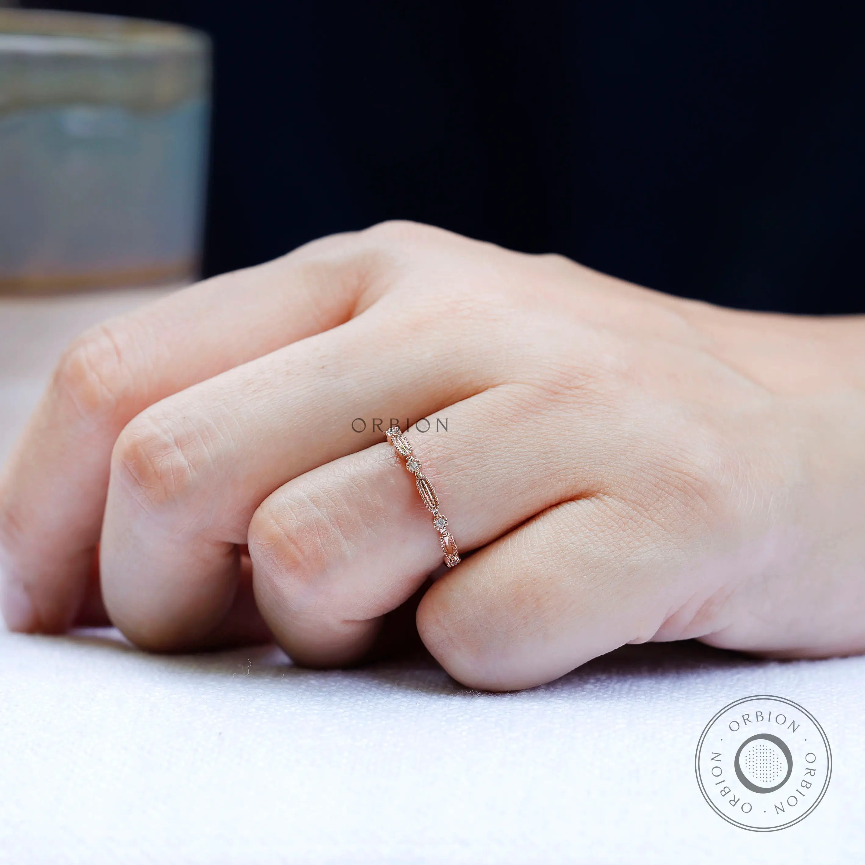 Top view geometric textured wedding band with round stone accents
