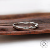 Angled view of geometric moissanite studded band
