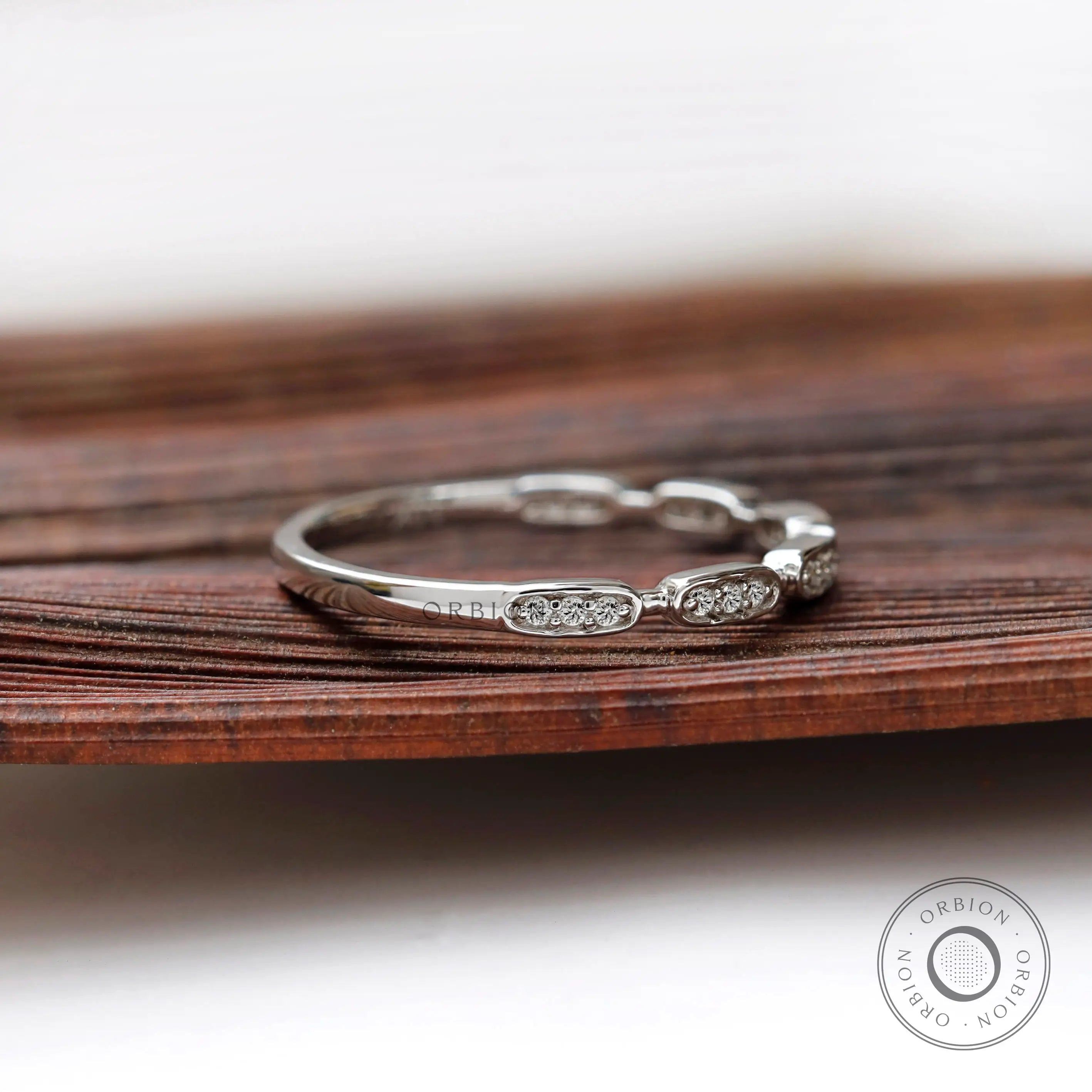 Angled view of geometric moissanite studded band