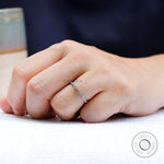 On-hand view showing slim geometric wedding band