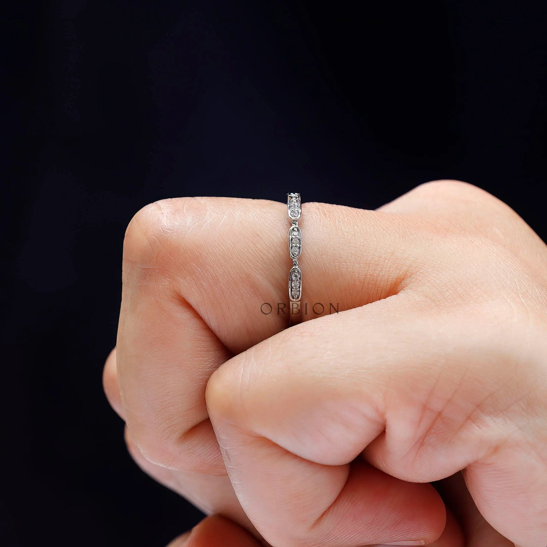Side view of geometric moissanite ring worn on hand