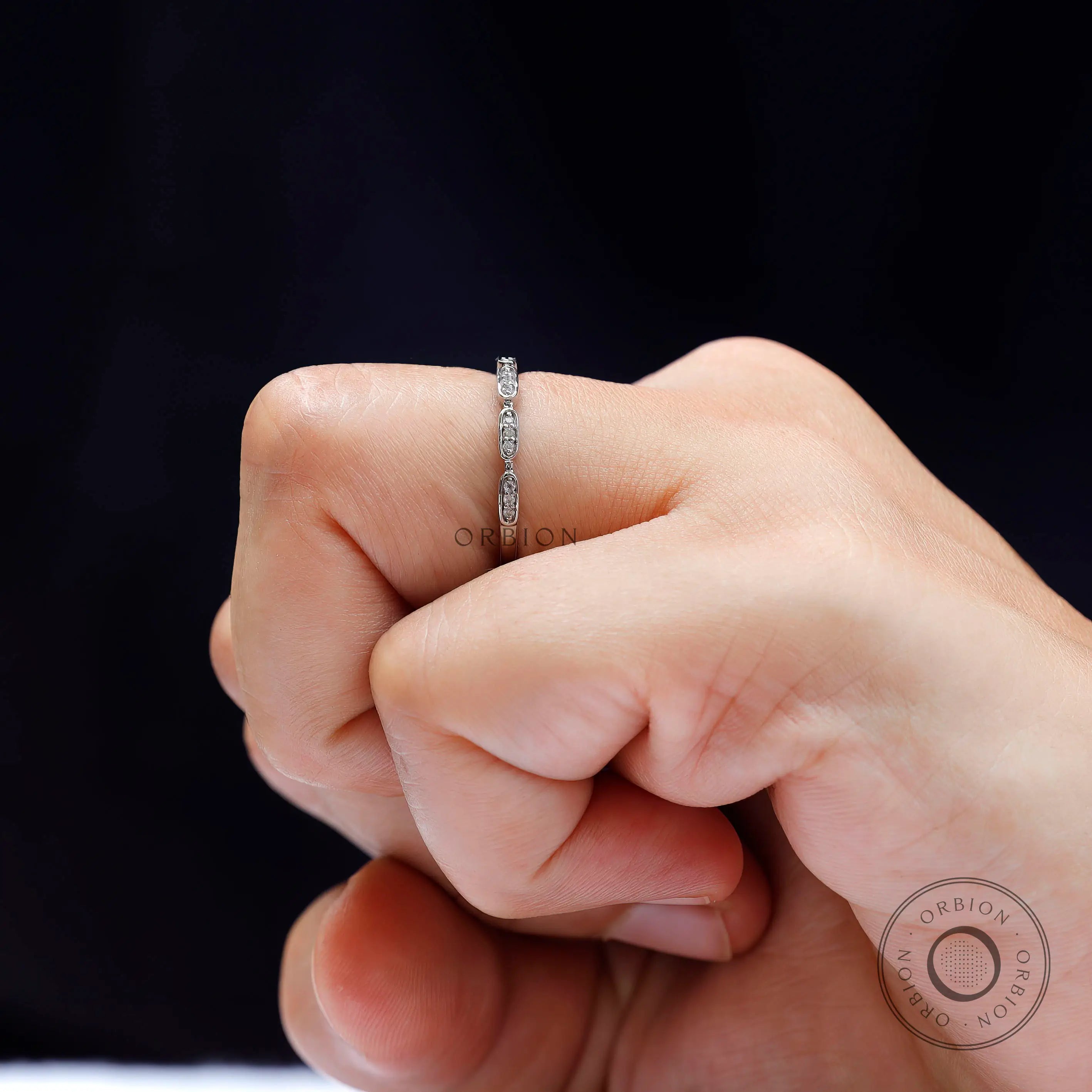 Side view of geometric moissanite ring worn on hand