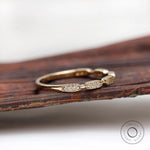 Angled side view showing milgrain details on wooden surface