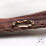 Back profile view of the gold band showing smooth shank