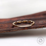 Back profile view of the gold band showing smooth shank