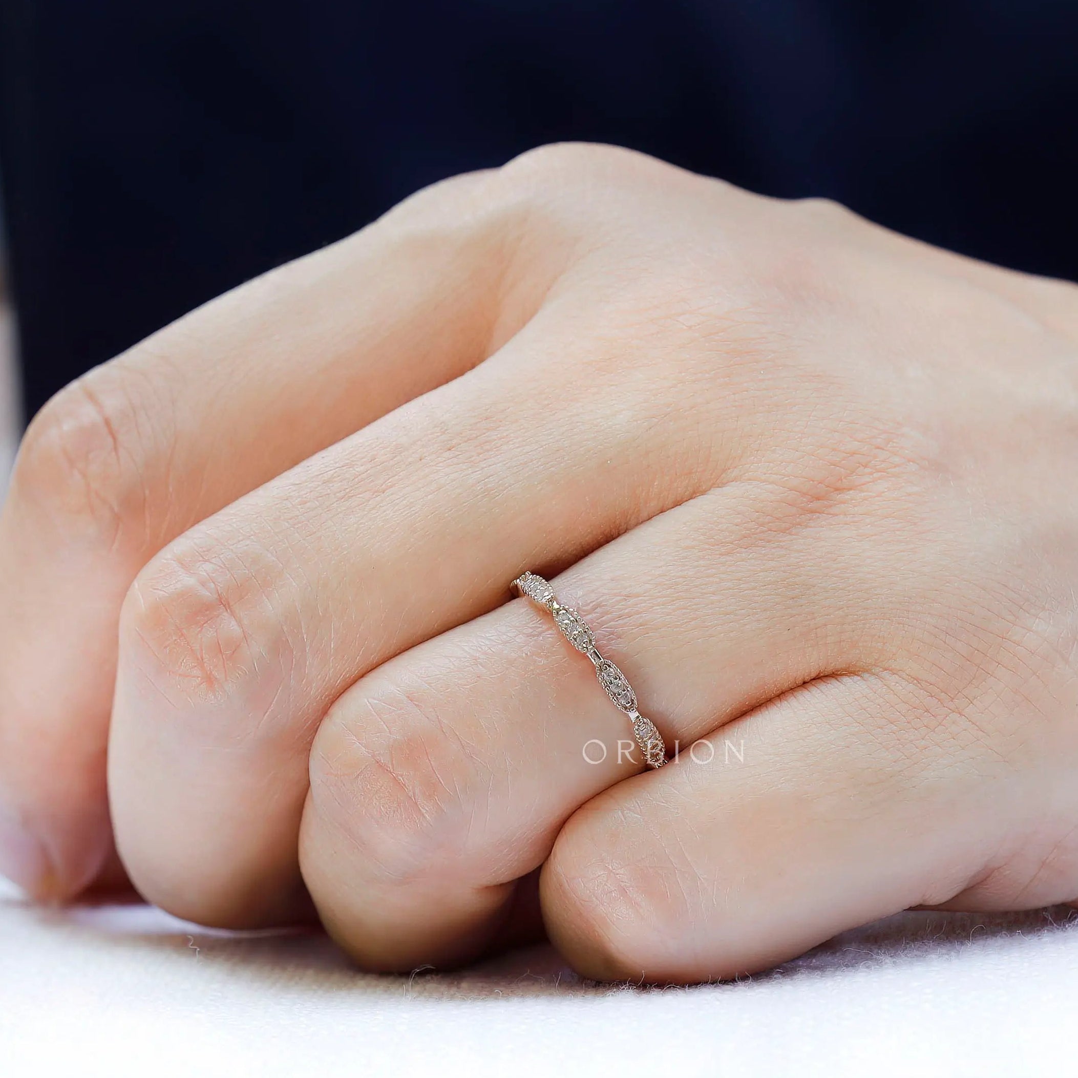 On-hand view of slim band, modern classic stacking band in yellow gold