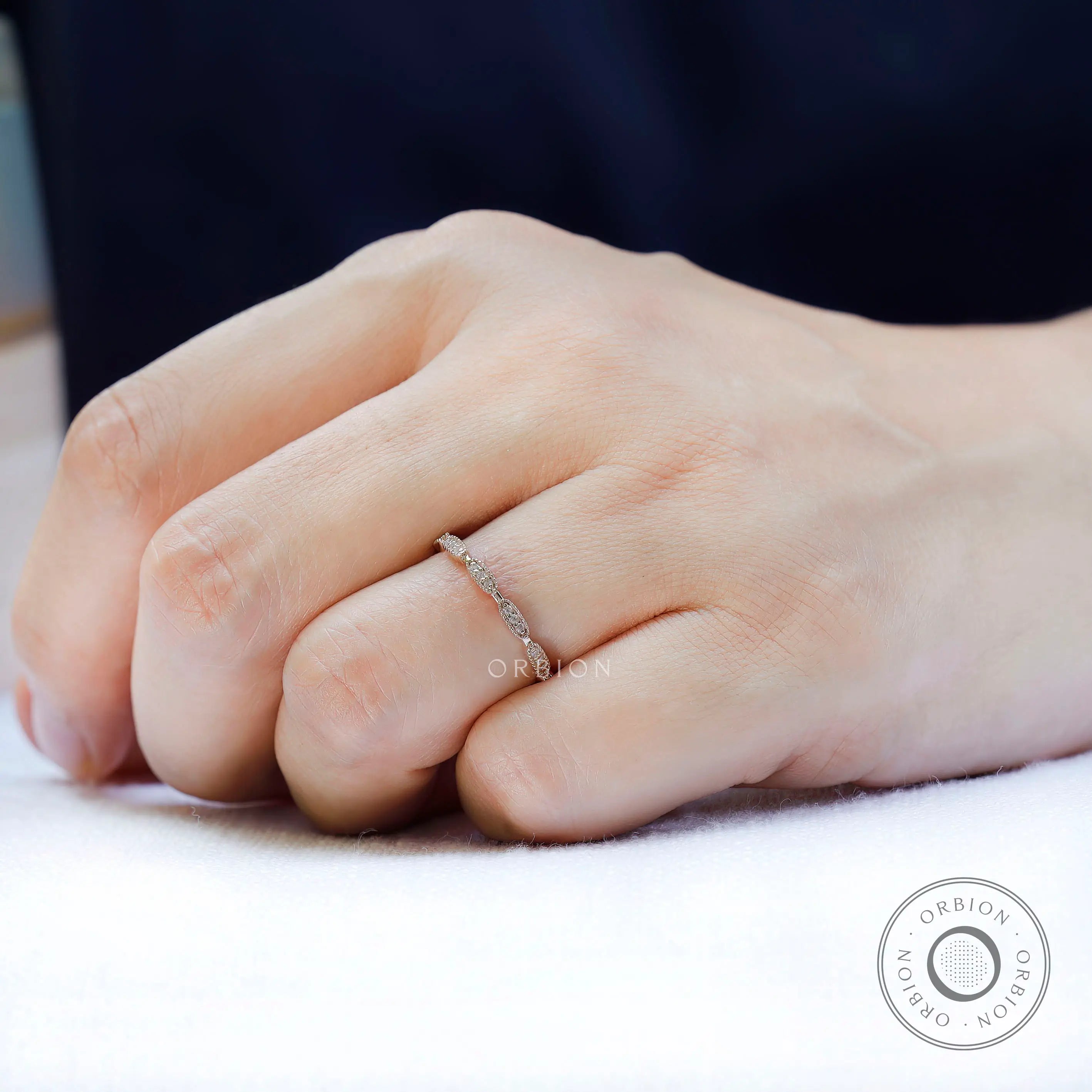 On-hand view of slim band, modern classic stacking band in yellow gold