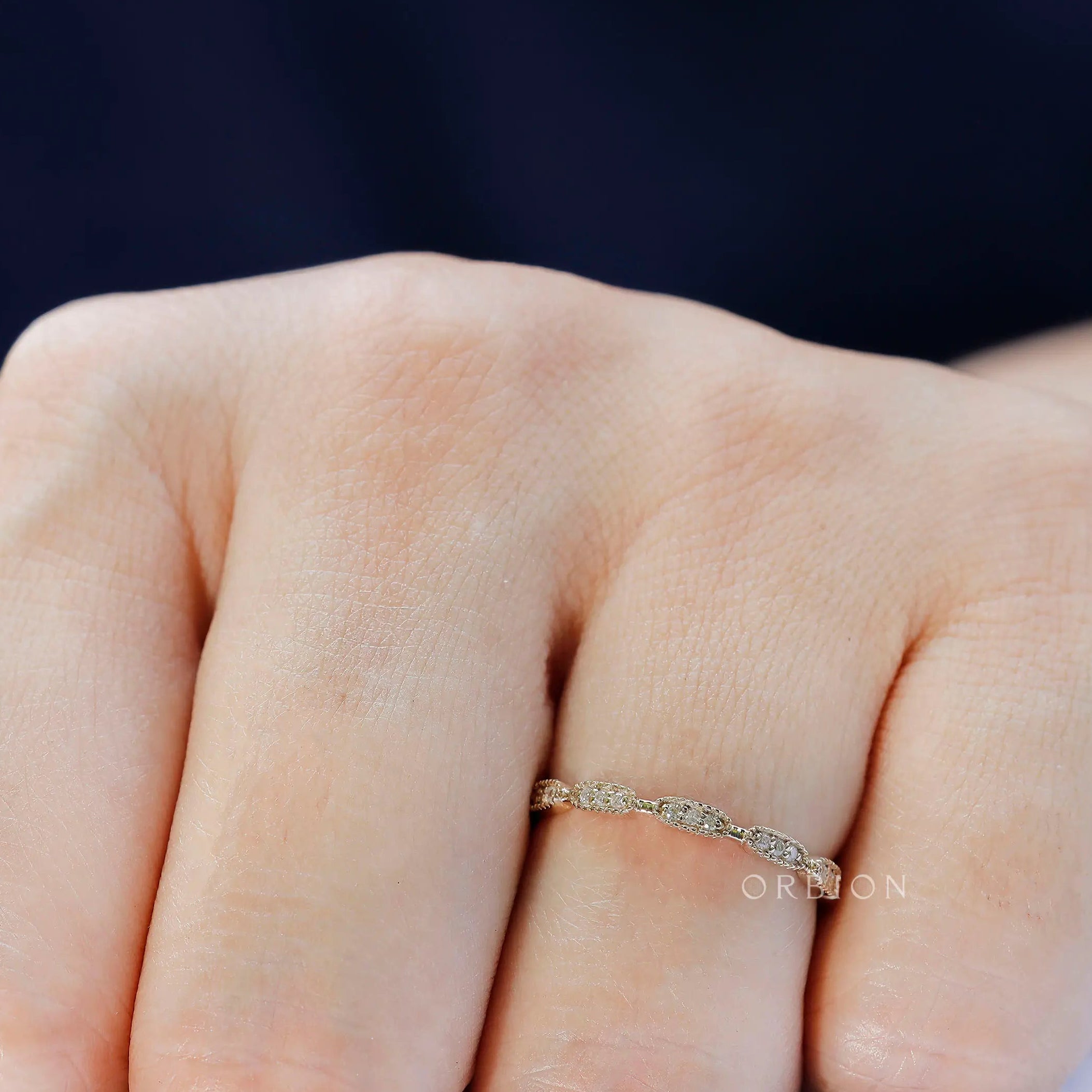 Worn view showing delicate Art Deco inspired, stackable gold band