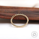 Back view of half eternity band highlighting clean bezel construction.