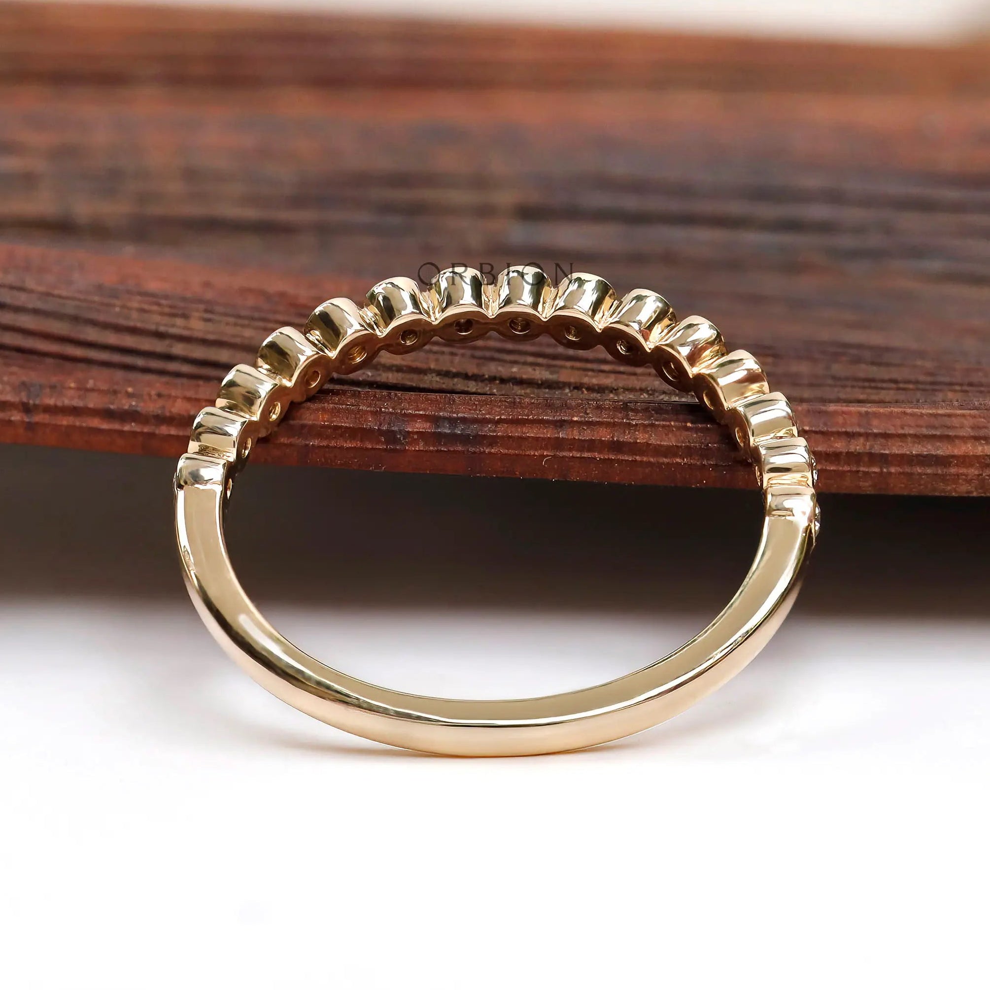 Back view of half eternity band highlighting clean bezel construction.