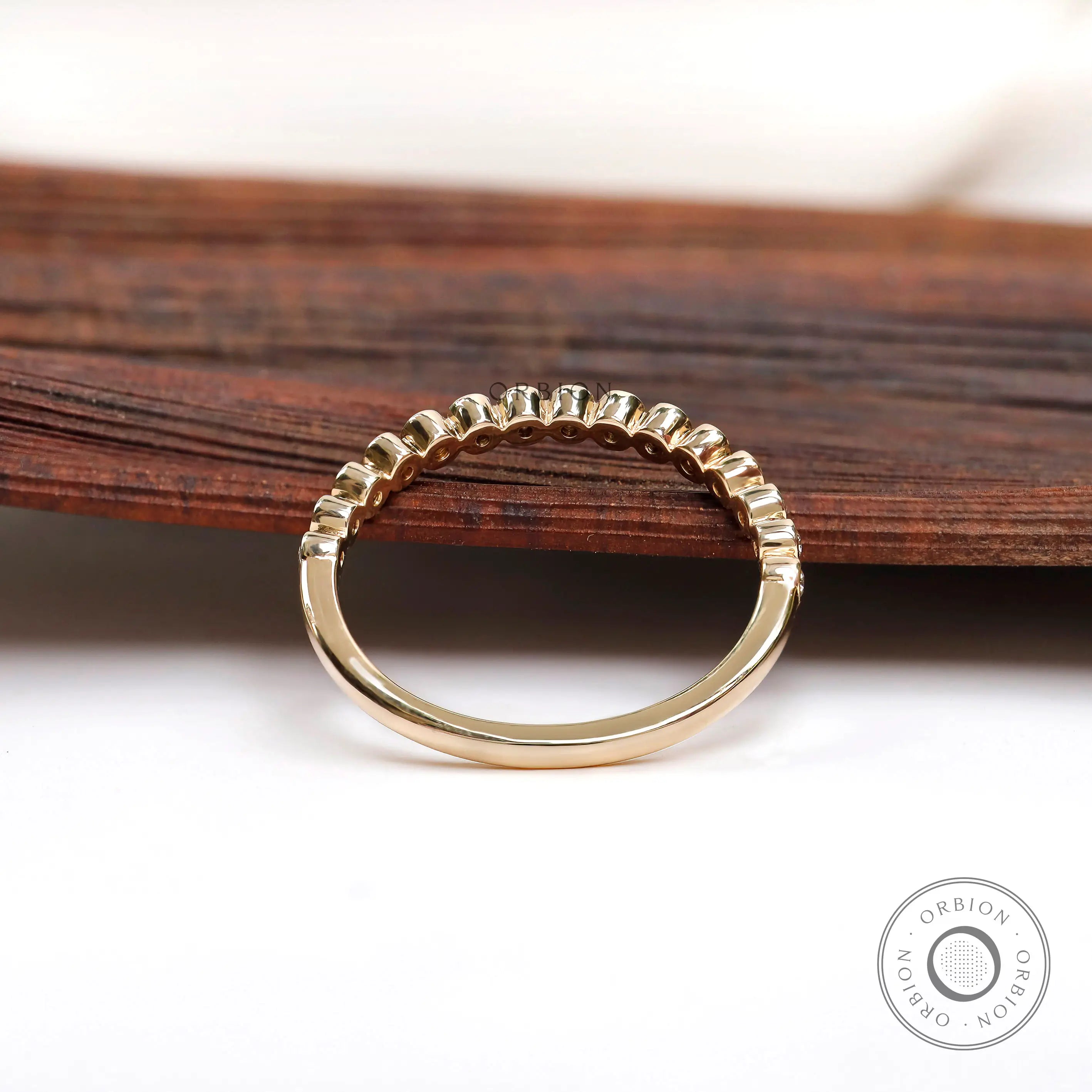 Back view of half eternity band highlighting clean bezel construction.
