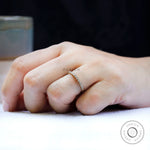 Lifestyle image of dainty bubble half eternity band worn on hand.
