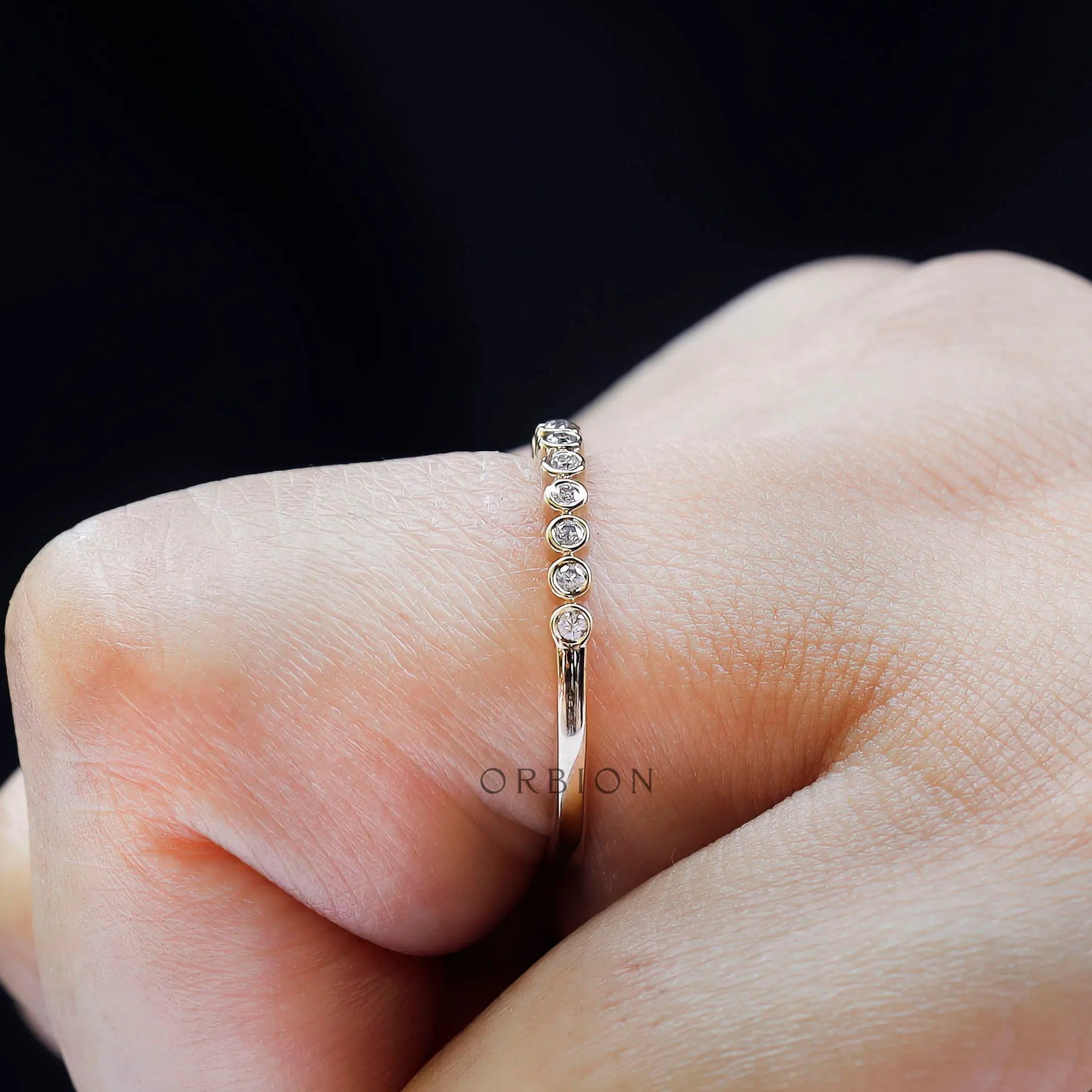 Side profile on hand displaying floating bubble stone setting design.