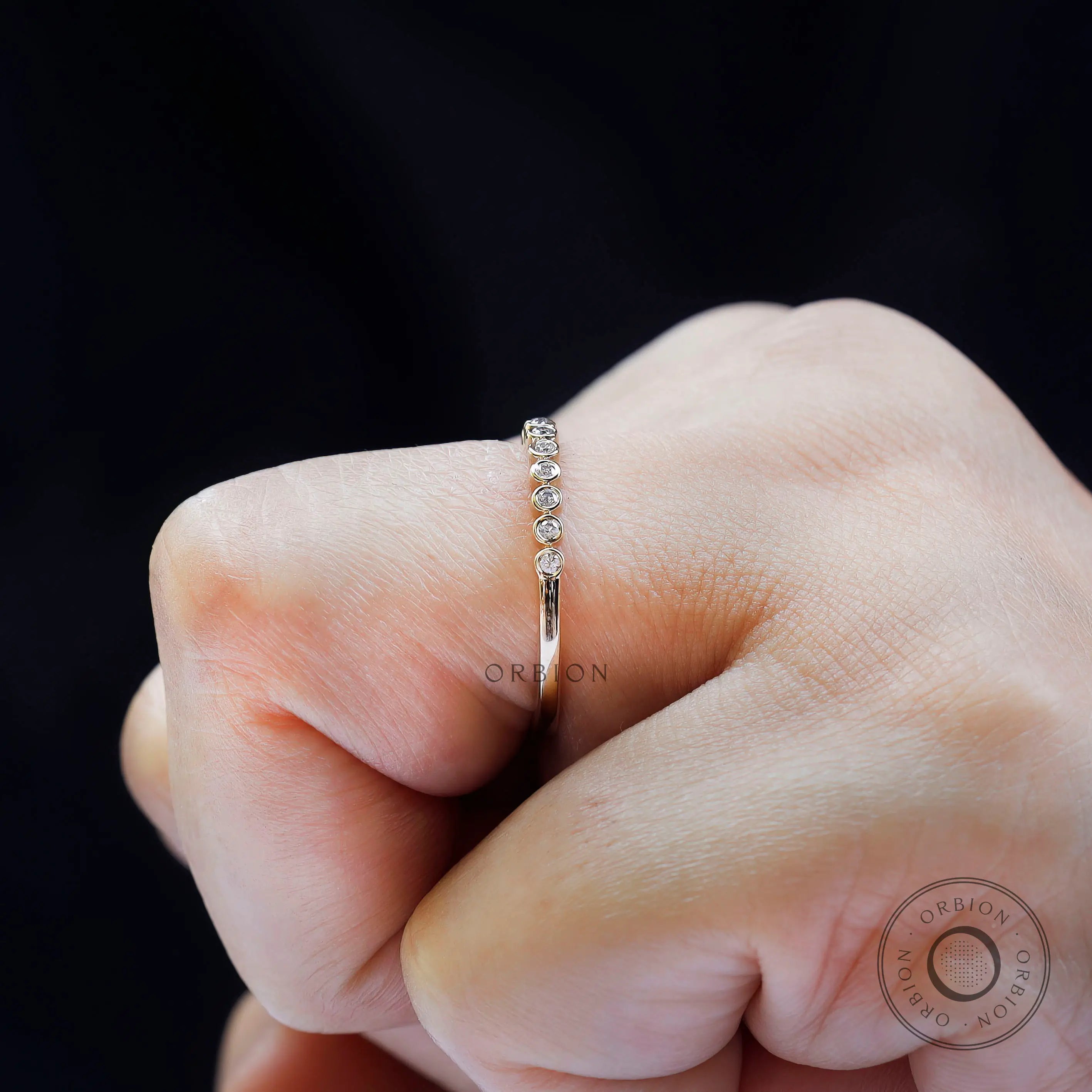 Side profile on hand displaying floating bubble stone setting design.