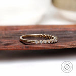 Angled side view of Art Deco bezel moissanite stacking wedding band in gold