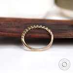 Underside and interior view of half eternity bezel set moissanite band