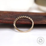 Underside and interior view of half eternity bezel set moissanite band