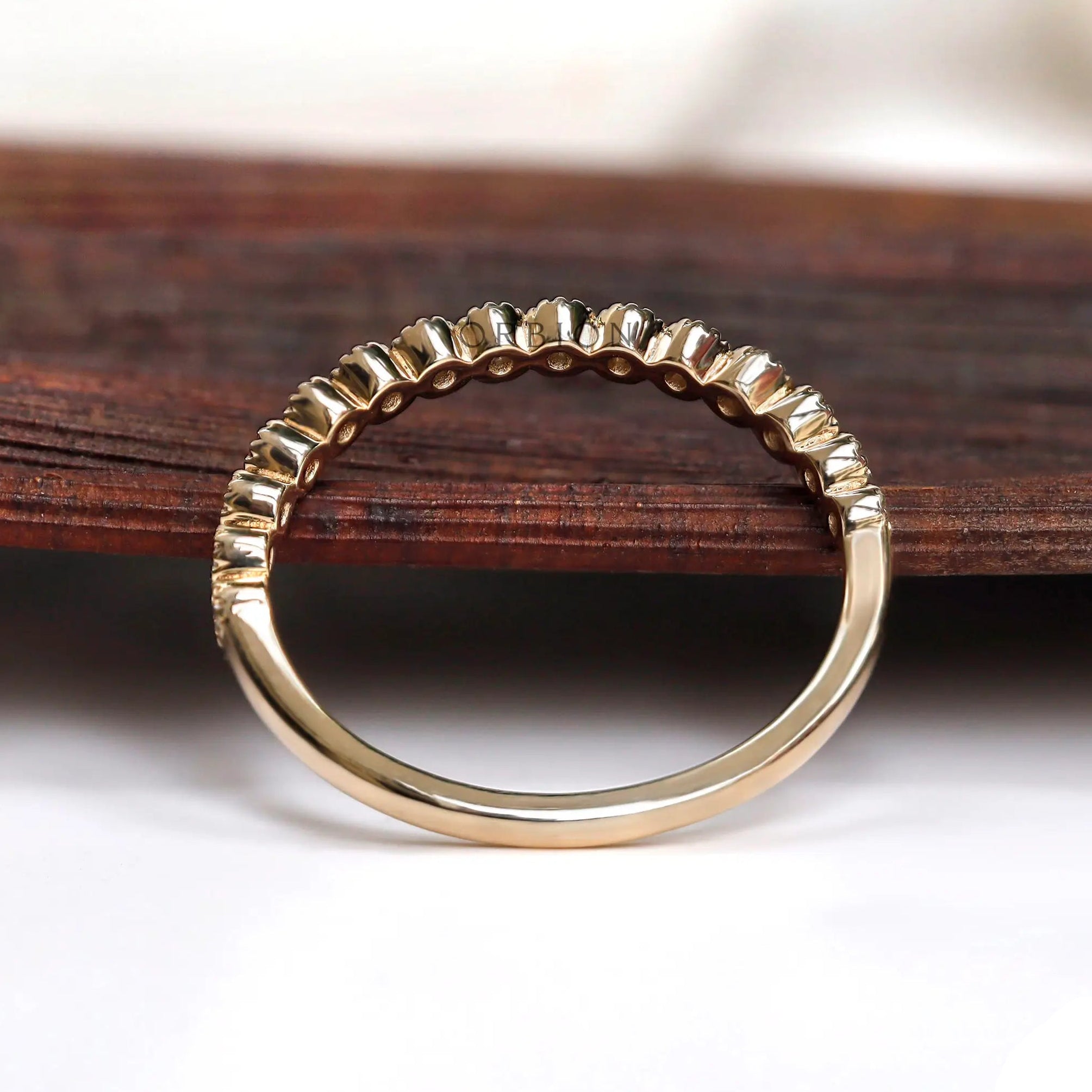 Underside and interior view of half eternity bezel set moissanite band