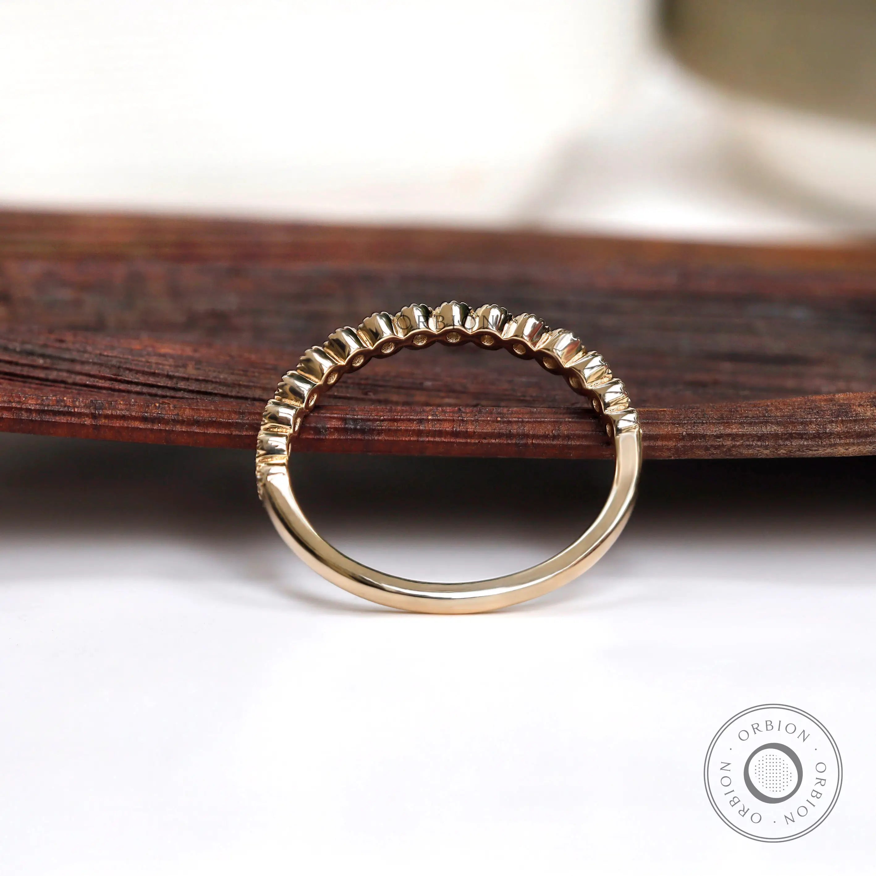 Underside and interior view of half eternity bezel set moissanite band