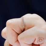 Side profile of slim bezel moissanite half eternity wedding band