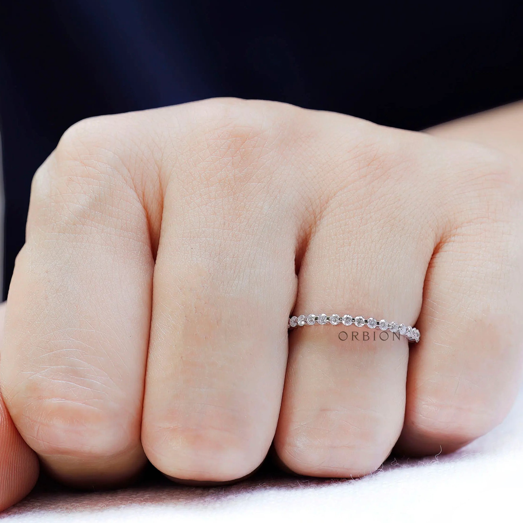 Round moissanite bubble eternity band worn on hand, minimalist stacking ring look