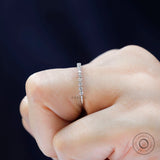 Side profile of bubble floating moissanite eternity wedding band on hand