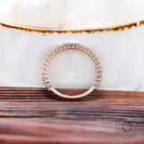 Profile view of U-prong setting and gallery on eternity band in rose gold