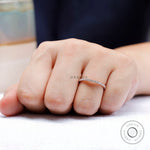 Slim U-prong wedding band in rose gold worn on hand showing low profile fit