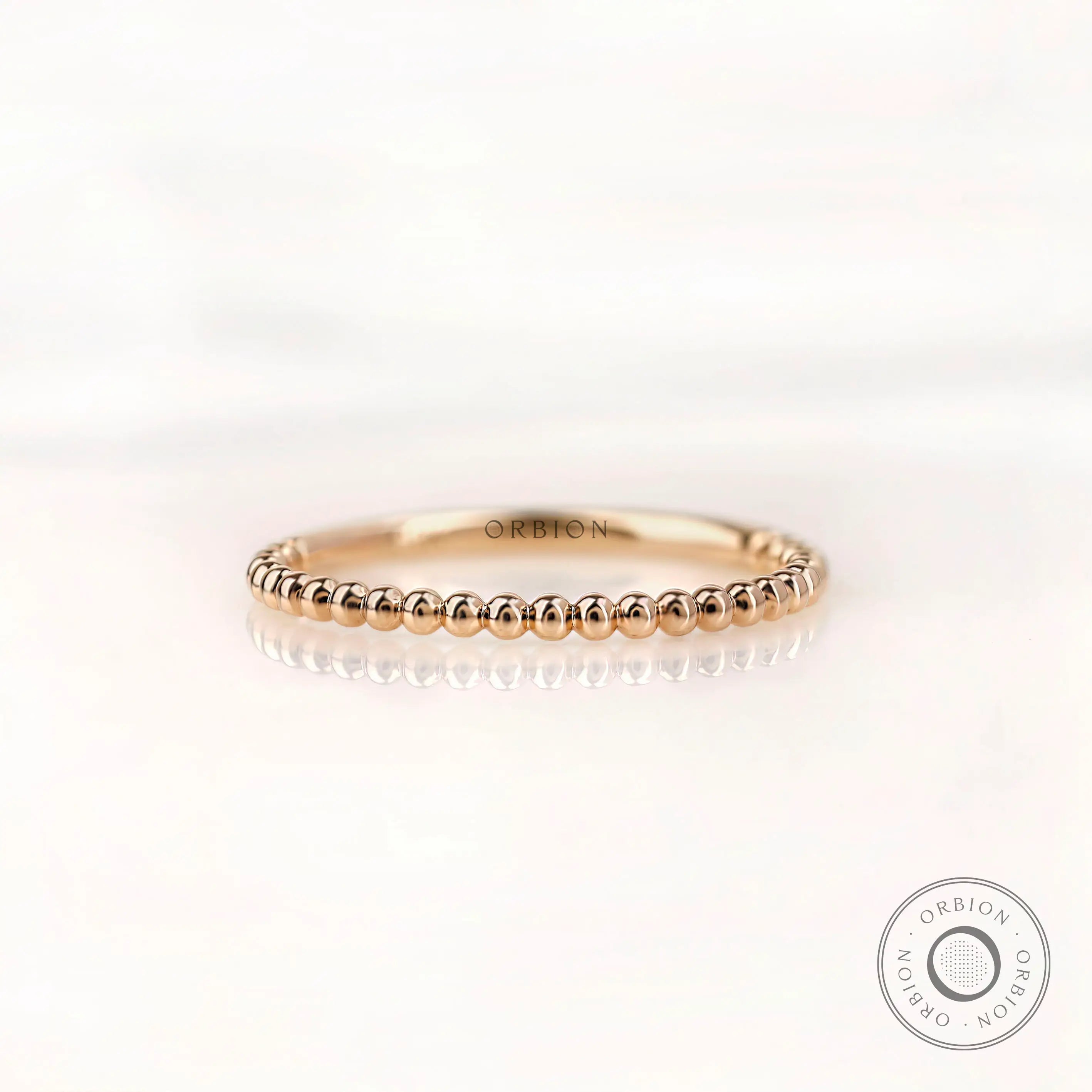 Front view of beaded ball gold dainty wedding band in yellow gold