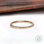 Top view of thin beaded gold band showing delicate ball detailing