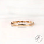 Back view of dainty beaded gold band with plain polished shank