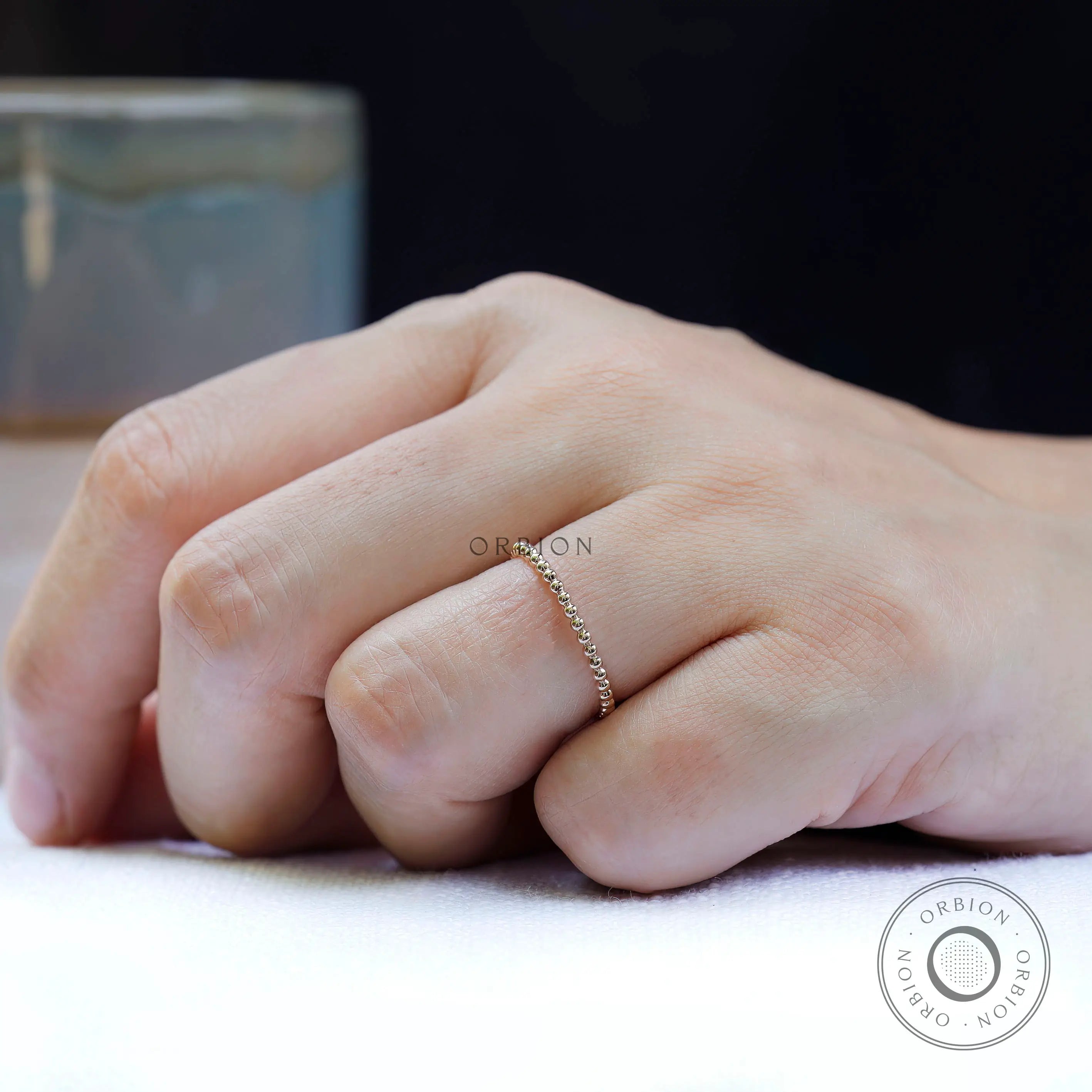 Beaded ball gold dotted wedding band worn on hand, minimalist style