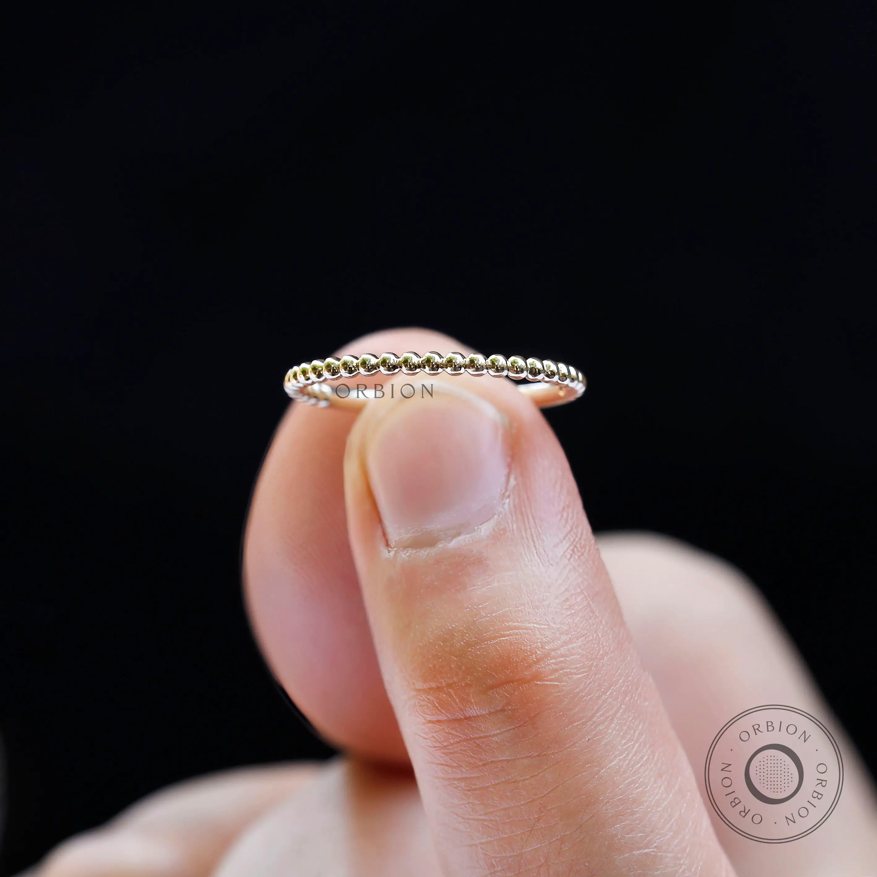 Close-up of gold dotted beaded band showing fine ball texture detail