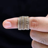 Beaded gold band stacked with other rings for layering inspiration